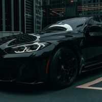 Uber Black luxury car sitting in a parking space.