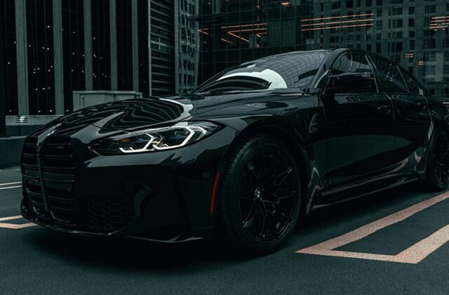 Uber Black luxury car sitting in a parking space.