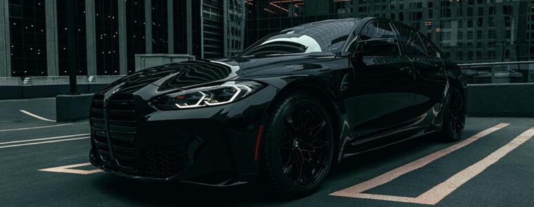 Uber Black luxury car sitting in a parking space.