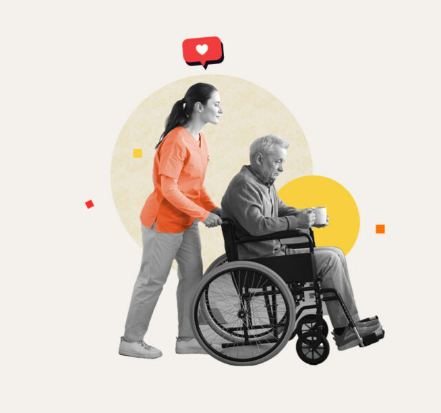 Caregiver pushing an elderly man in a wheelchair