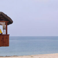 Professional lifeguard sitting at their post on a beach and monitoring the waters