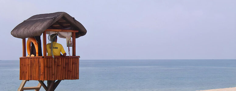 Professional lifeguard sitting at their post on a beach and monitoring the waters