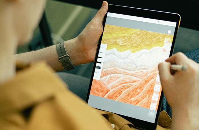 Designer working on a printable digital download on a graphics tablet.