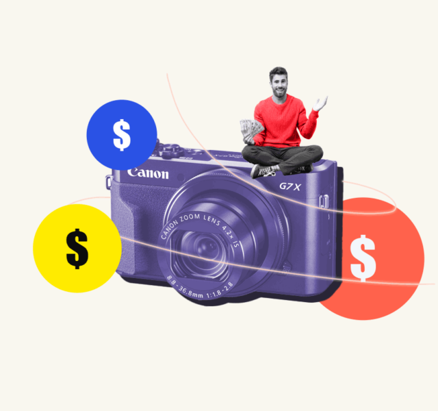 New photographer sitting on oversized camera decorated with money signs