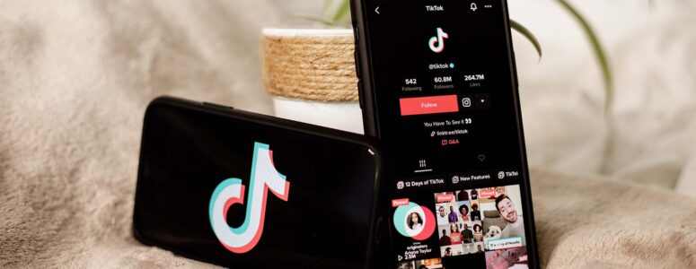 Two smartphones displaying the TikTok logo and profile page for a paid TikToker