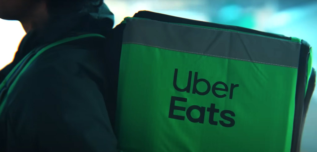 Close view of an Uber Eats bag on a delivery person's back