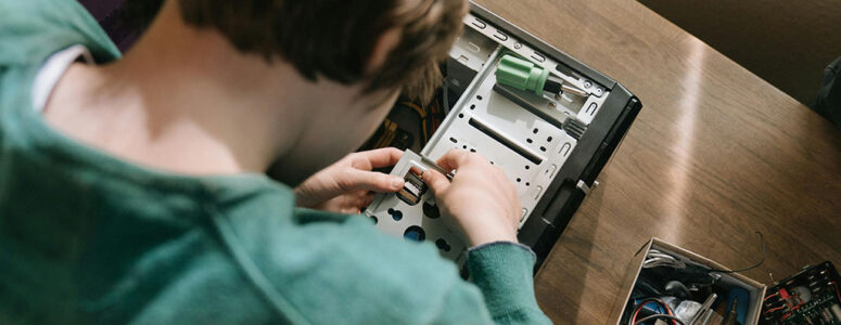 Computer repair business owner repairing computer hardware for a customer