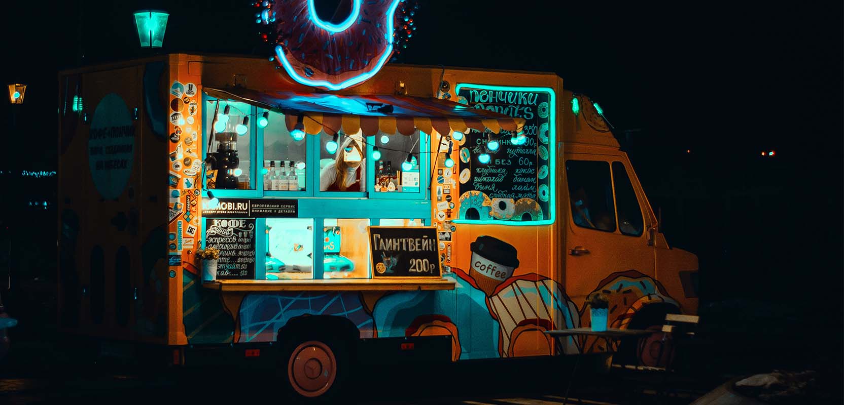 A food truck selling food on the side of the street.