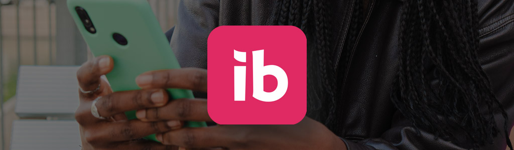 Ibotta logo against the background of someone shopping on their phone