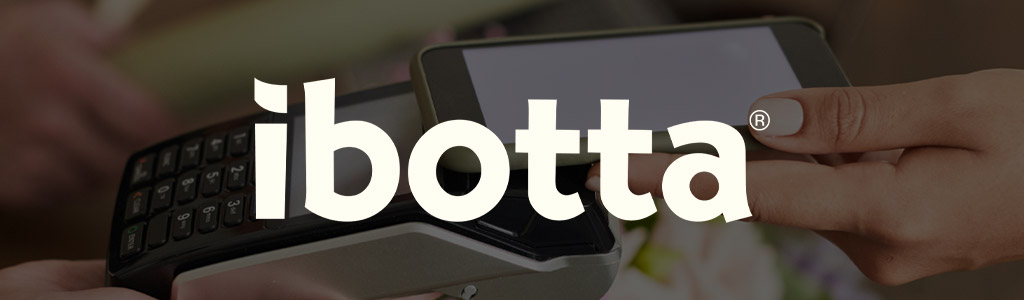 Ibotta logo against a background of someone checking out using their mobile phone