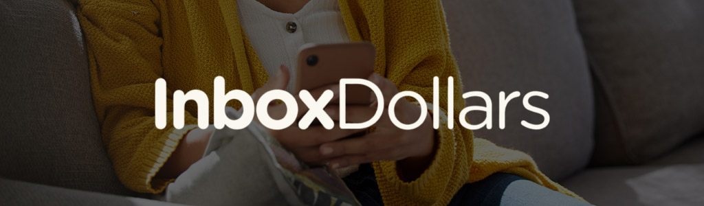 InboxDollars logo against a background of someone using their mobile phone