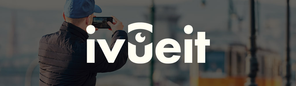 iVueit logo against a darkened background showing someone taking a picture of something with their phone
