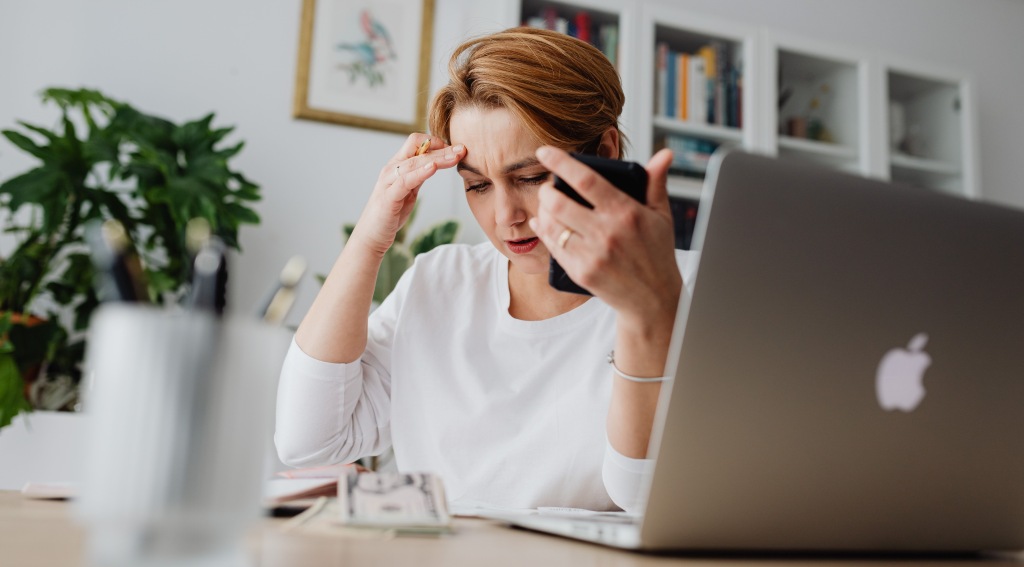 Worried job hunter contemplating her employment prospects after declaring bankruptcy.