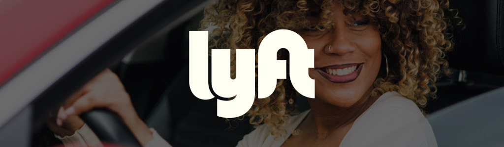 Lyft logo against a background of a woman driving a car
