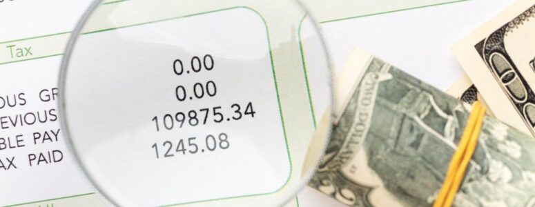 Magnifying glass viewing salary information.