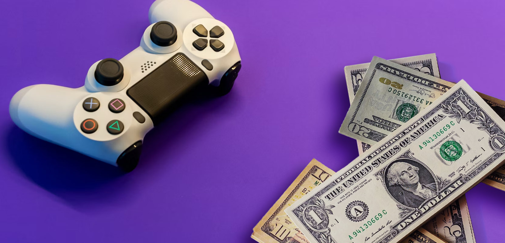PlayStation controller sitting next to a pile of money