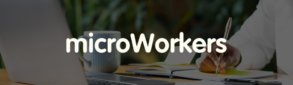 Microworkers logo against a darkened background showing a freelancer with a cup, a laptop, and a notebook 