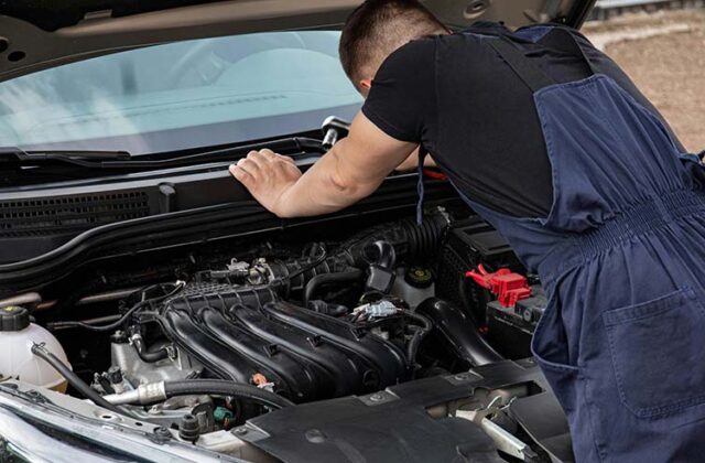 Mobile mechanic working on a customer's car.