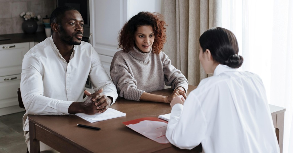 A parent sitting in an interview with their Gen Z child.