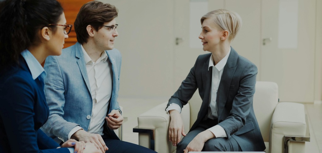 A mother in a meeting with her Gen Z son helping him negotiate his salary with his manager.