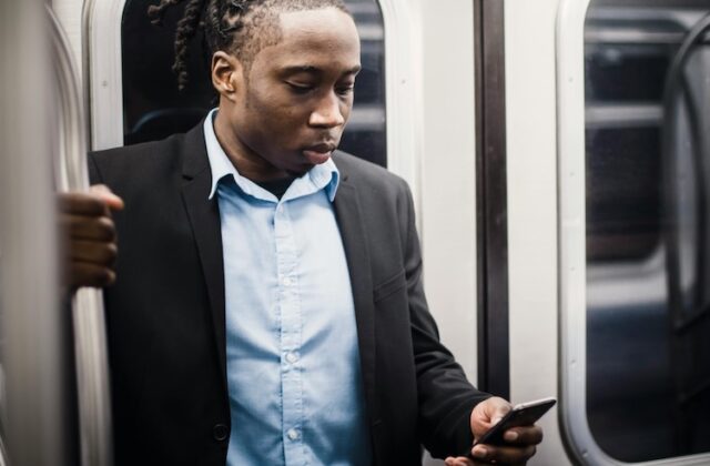 Pawns.app user looking at his phone during his daily commute.