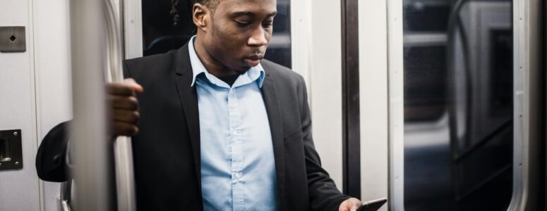 Pawns.app user looking at his phone during his daily commute.