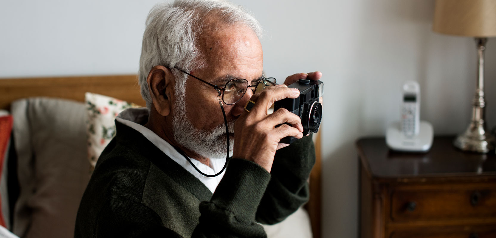 Older man taking a picture for his photography side hustle