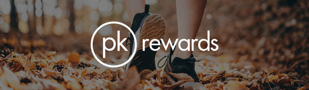 PK Rewards logo against a background showing someone walking on the ground in the autumn