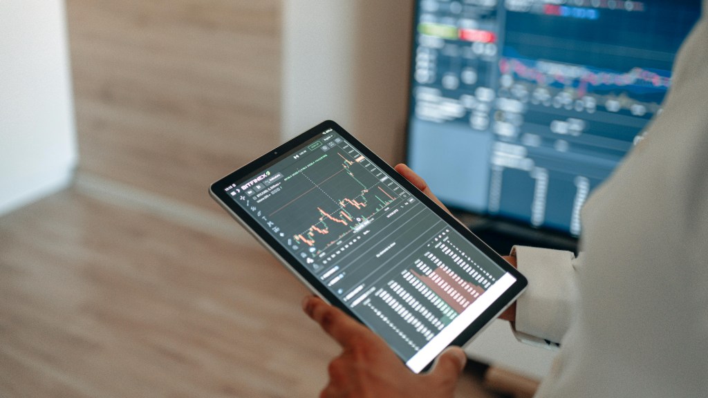 Someone researching trends on multiple devices before placing bets on prediction markets.