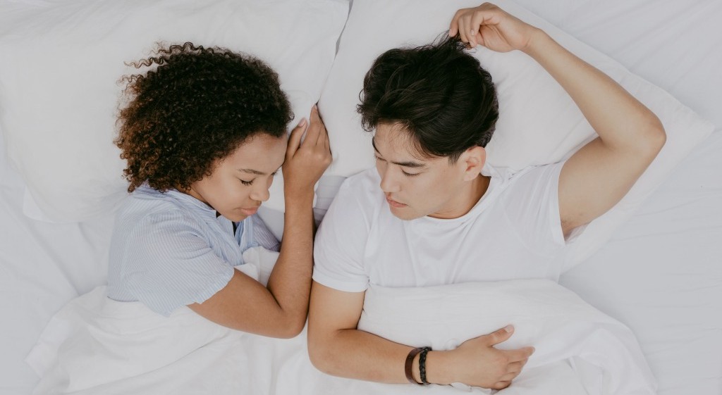 Professional cuddler lying side-by-side with customer after enforcing a boundary.