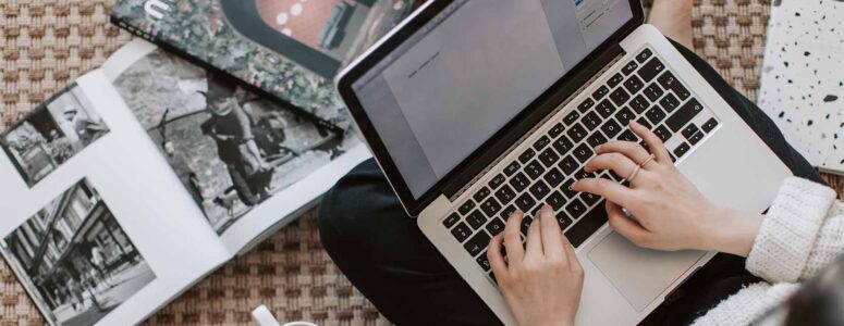 writer with hands on laptop submitting articles to publications