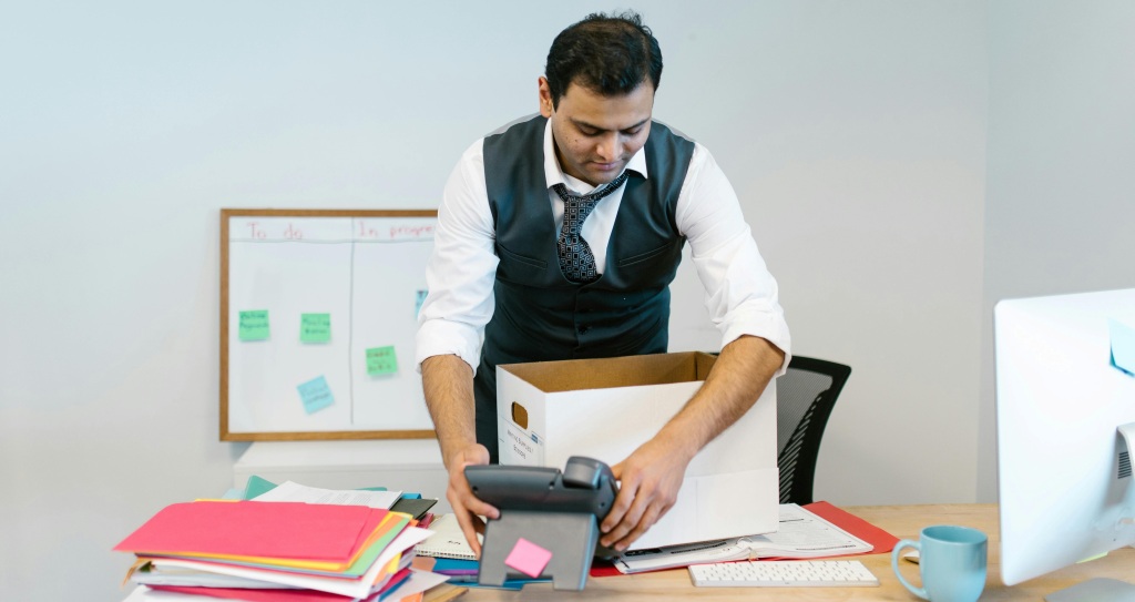 Freelance writer packing their desk after quitting to pursue writing.