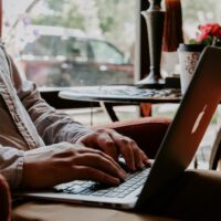 Close view of man using RemoteOK on his laptop.