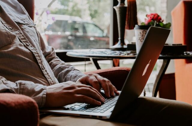 Close view of man using RemoteOK on his laptop.