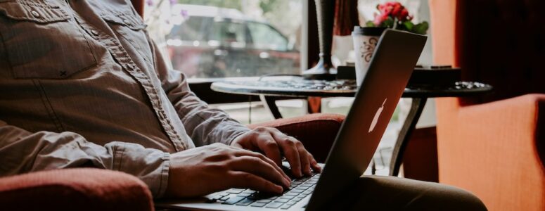 Close view of man using RemoteOK on his laptop.