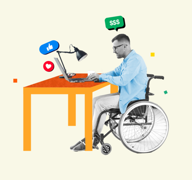 Man in a wheelchair sitting at a desk working on a side hustle