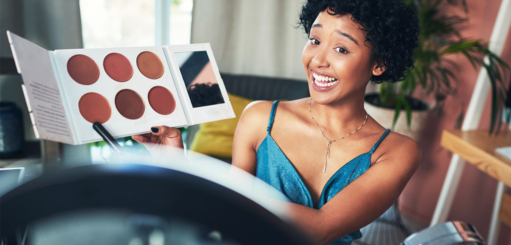 Woman pointing at makeup while reviewing it for her side hustle