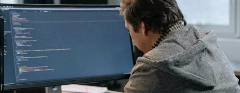 Software engineer writing code on a computer.