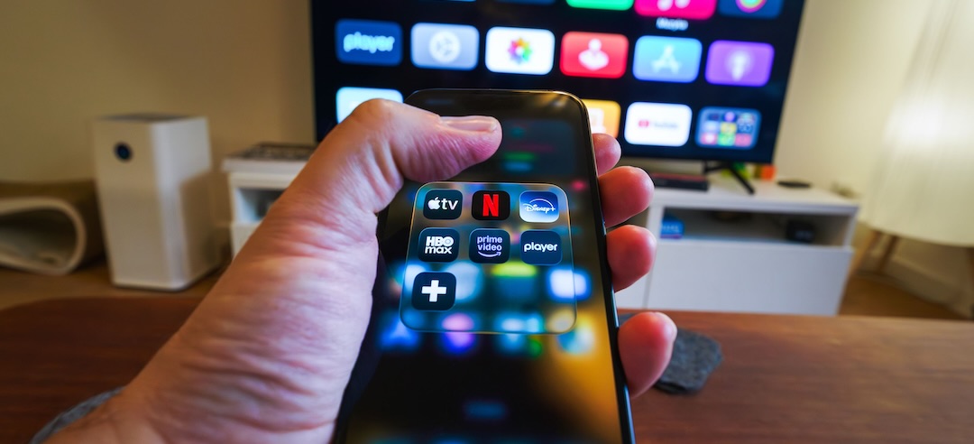 Closeup of a person's phone with various streaming apps displayed.