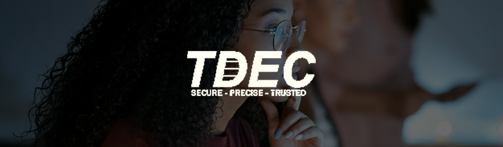 TDEC logo against a darkened background showing a freelancer concentrating