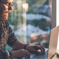 Gig worker annotating data on his laptop for TELUS Digital.