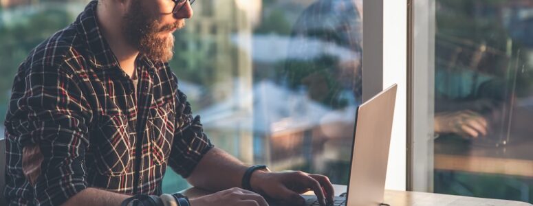 Gig worker annotating data on his laptop for TELUS Digital.