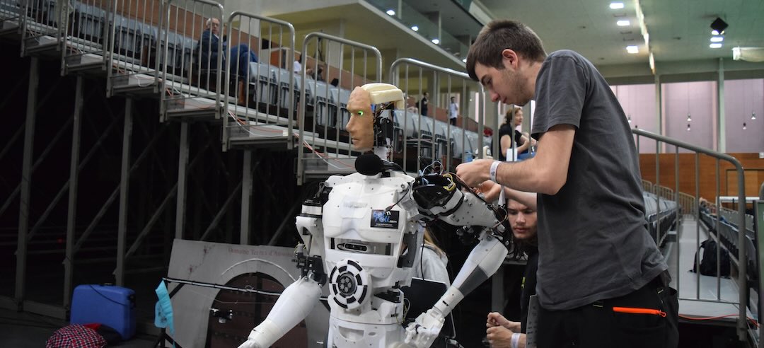 Person maintaining a humanoid robot.