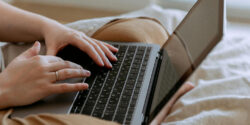 Close view of a freelance writer's hands on their keyboard.