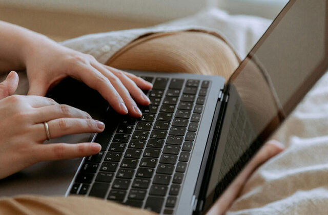 Close view of a freelance writer's hands on their keyboard.