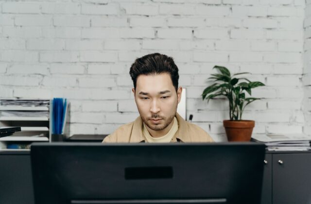 Typist working at a computer in an office.