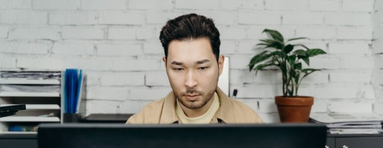 Typist working at a computer in an office.