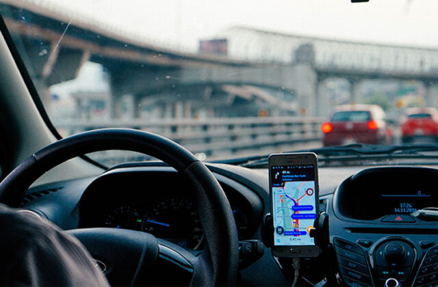 An Uber driver behind the wheel of his car.