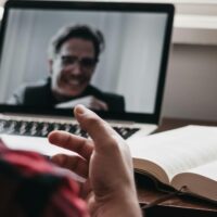 Close view of a laptop screen showing a virtual assistant's job interview in progress.