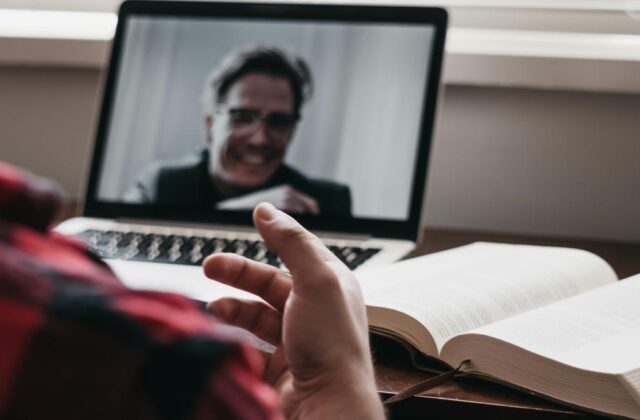 Close view of a laptop screen showing a virtual assistant's job interview in progress.